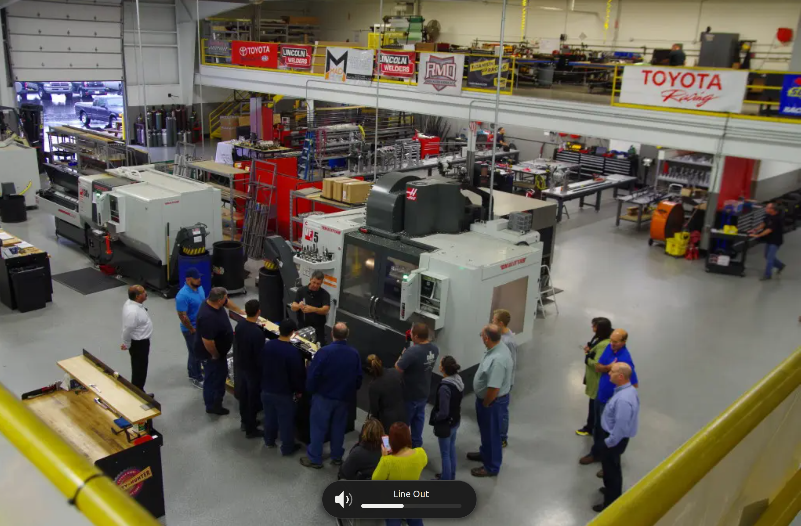 Machine shop floor with Haas CNC machines and crew